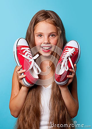 Young smiling girl with red gumshoes Stock Photo
