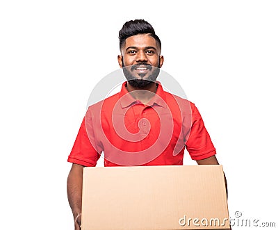 Young smiling indian logistic delivery man in red uniform holding the box on white background Stock Photo