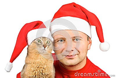 Young smiling man and cat in Santa's hat Stock Photo