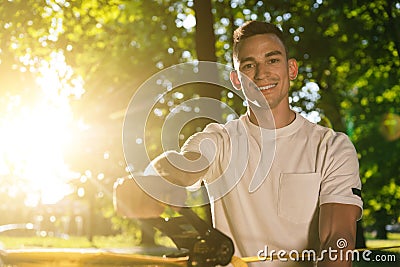 Young smiling man in the forest practising slacklining Stock Photo