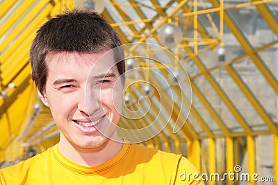 Young smiling man in yellow shirt Stock Photo