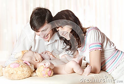 Young smiling parents looking at baby Stock Photo