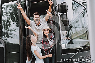 Young Smiling People Traveling on Tourist Bus Stock Photo