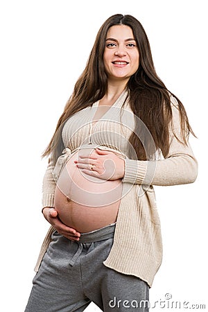 Young smiling pregnant woman grabbing her tummy Stock Photo