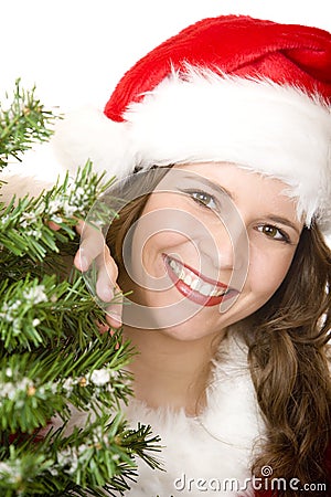 Young smiling Santa Woman near Christmas tree Stock Photo