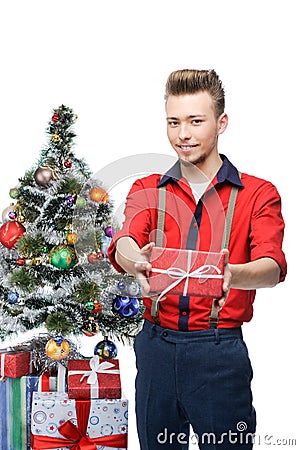 Young smiling vintage man holding gift near Stock Photo