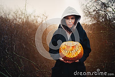 Young smiling woman holding the halloween pumpkin Stock Photo