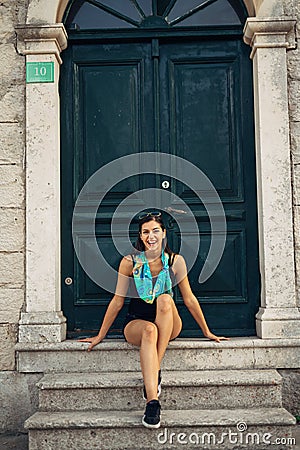 Young smiling woman travelling and visiting Europe.Summer touring Europe and Mediterranean culture.Colourful streets,old Stock Photo