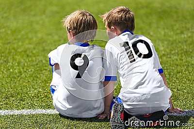 Young Soccer Football Players. Little Boys Sitting on Soccer Pitch Editorial Stock Photo