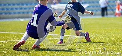 Young soccer goalkeeper save. Boy catching soccer ball Stock Photo