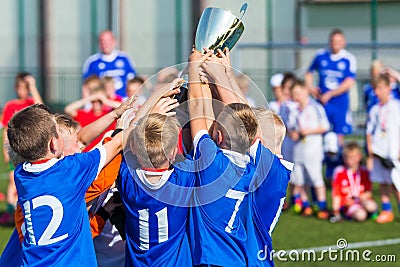 Young Soccer Players Holding Trophy. Boys Celebrating Soccer Football Championship Editorial Stock Photo