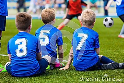 Young soccer team. Reserve players sitting together and watching Editorial Stock Photo