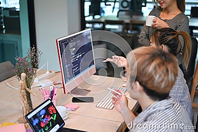 Young software developers team working together for developing website design and coding technologies at creative office Stock Photo