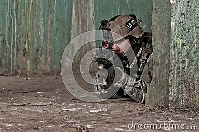 Young soldier behind obstacle Stock Photo