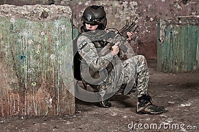 Young soldier behind obstacle Stock Photo