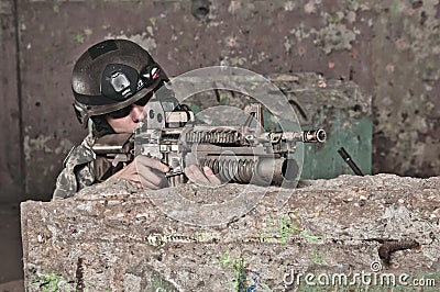 Young soldier behind obstacle Stock Photo