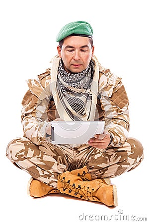 Young soldier using his tablet computer Stock Photo