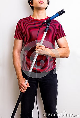Young sound man with boom Stock Photo
