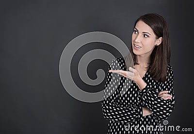 Young spanish woman presenting with hand on blackboard. Stock Photo