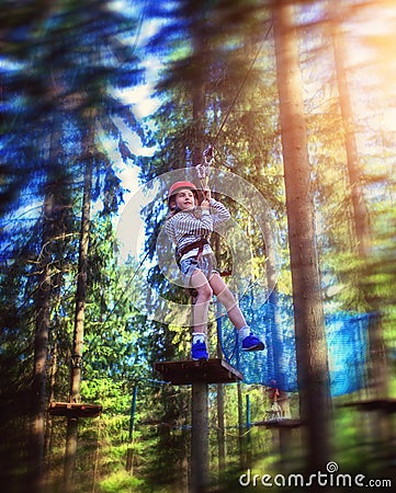 Young girl rides down a zipline Stock Photo