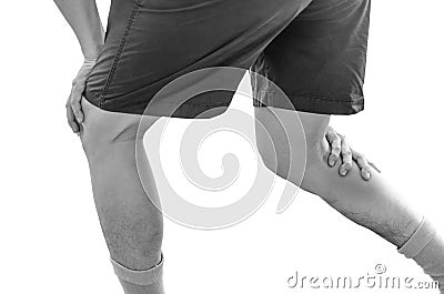 Young sport man with strong athletic legs holding knee Stock Photo