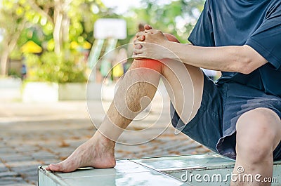 Young sport man with strong athletic legs holding knee Stock Photo