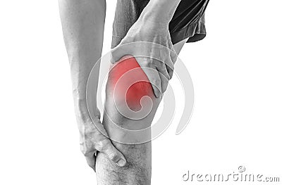 Young sport man with strong athletic legs holding knee with his Stock Photo