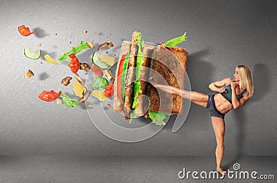 Young sport women boxing a hamburger as unhealthy food Stock Photo