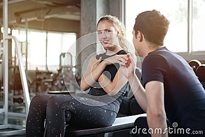 young sport woman exercise doing sit ups on the bench in fitness gym healthy .Muscular girl in sportswear training abs with Stock Photo