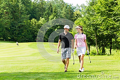 Young sportive couple playing golf on a course Stock Photo