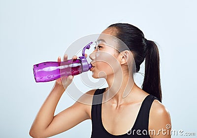 Young sports woman drinks bottled water Stock Photo