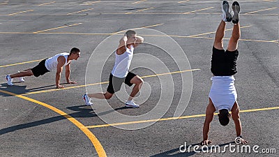 Young sportsman doing gymnastic exercises outdoors Stock Photo