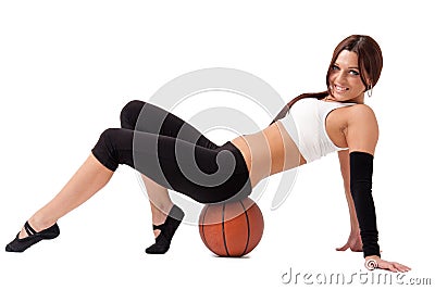 Young sportswoman sitting on basketball Stock Photo