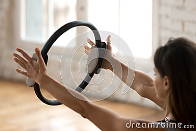 Young sporty woman practicing fitness exercise with a pilates ri Stock Photo