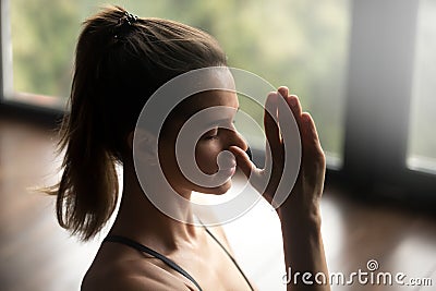 Young sporty woman in Alternate Nostril Breathing Stock Photo