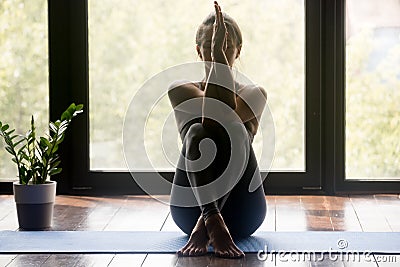 Young sporty woman doing Garudasana arms exercise Stock Photo