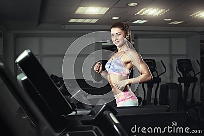 Young sporty woman run on machine in the gym Stock Photo