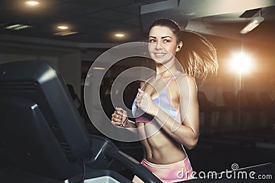 Young sporty woman run on machine in the gym Stock Photo