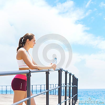 Young and sporty woman training in outdoor gym. Fitness, sport and health care. Stock Photo