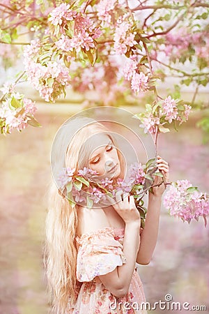 Young spring fashion woman in spring garden. Springtime. Trendy Stock Photo