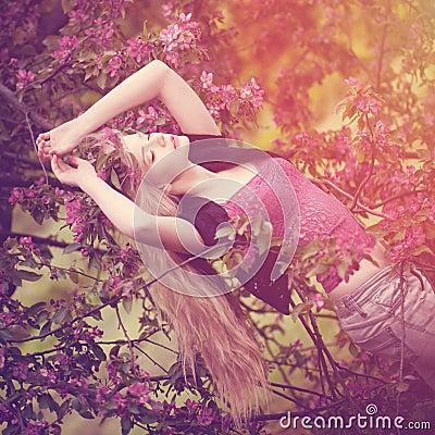 Young spring fashion woman in spring garden. Springtime. Trendy Stock Photo