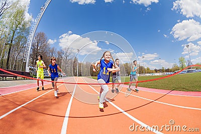 Young sprinters running to the finish line Stock Photo