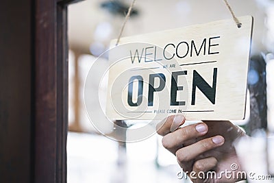 Young startup coffee cafe owener open and welcome customer Stock Photo