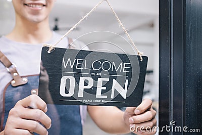 Young startup coffee cafe owener open and welcome customer Stock Photo