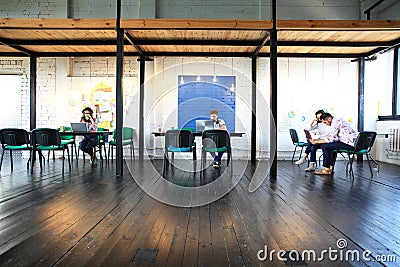 Young startup group working in modern office. Open space, laptops and paperwork Stock Photo