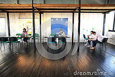 Young startup group working in modern office. Open space, laptops and paperwork Stock Photo