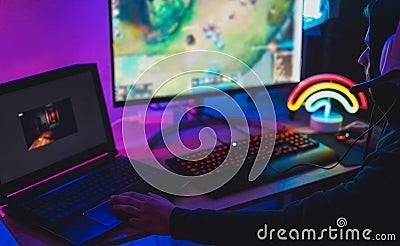 Young streamer gamer playing at strategy game in broadcast browser - Male guy having fun gaming and streaming online - New Stock Photo