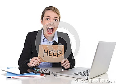 Young stressed businesswoman holding help sign overworked at office computer Stock Photo