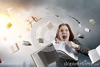 Young stressed woman ripping documents with frustrated facial expression. Stock Photo