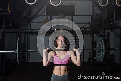 Young strong muscular fit girl with big muscles preparing for hard strength weight lifting or dead lift cross workout training wit Stock Photo